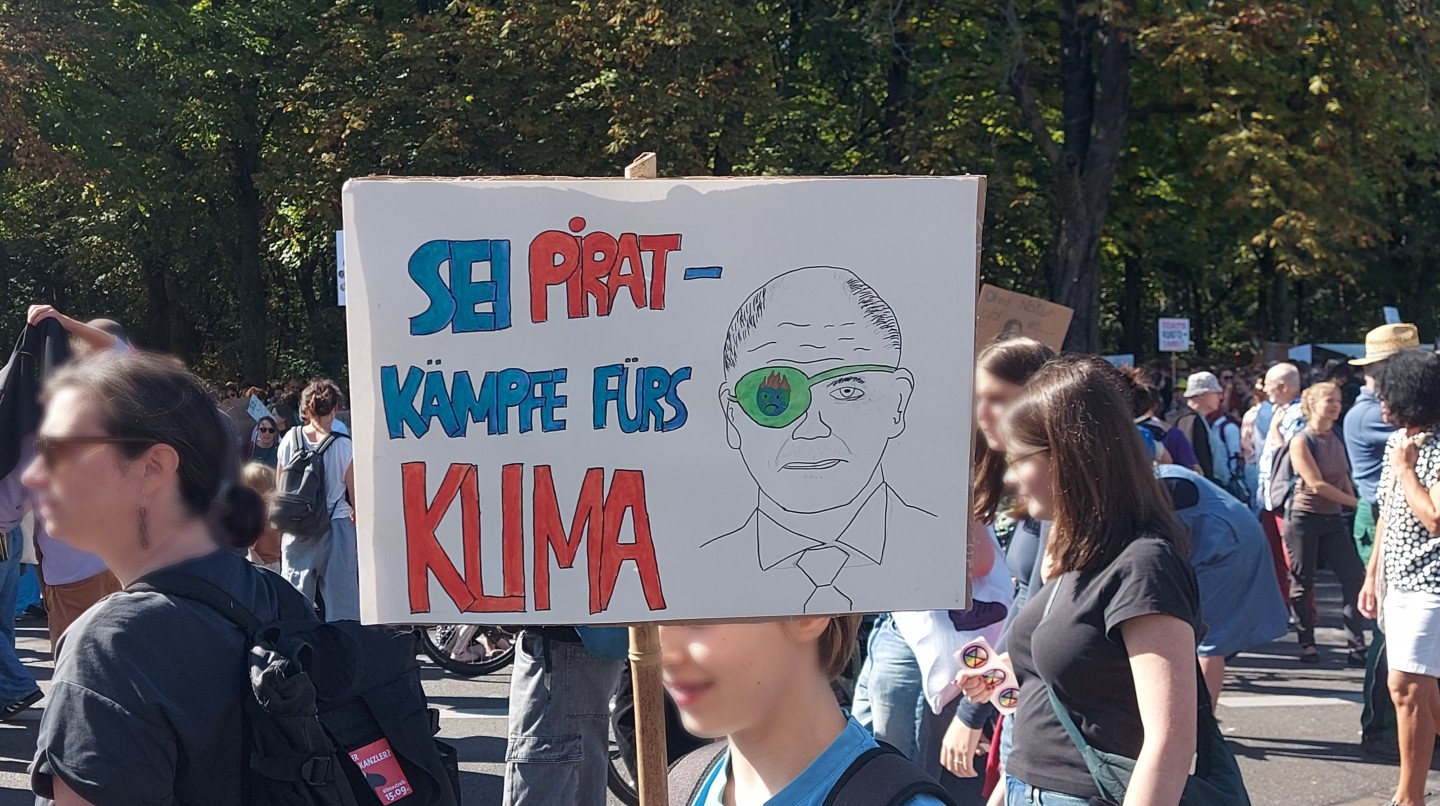 Plakat mit Titel und Bundespräsident Olaf Scholz