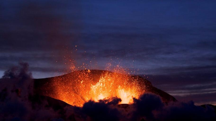 Vulkanausbruch auf Island. rot, gelbe Lava spritzt aus einer dunklen Masse. 