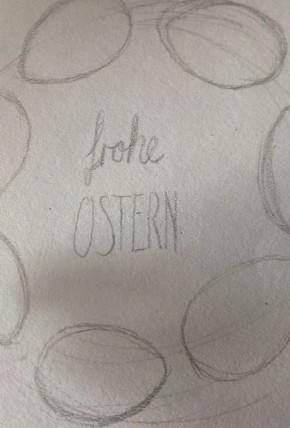 Skizze für eine Osterkarte. In der Mitte steht "frohe Ostern". Die Worte stehen in einem Kranz aus Ostereiern.