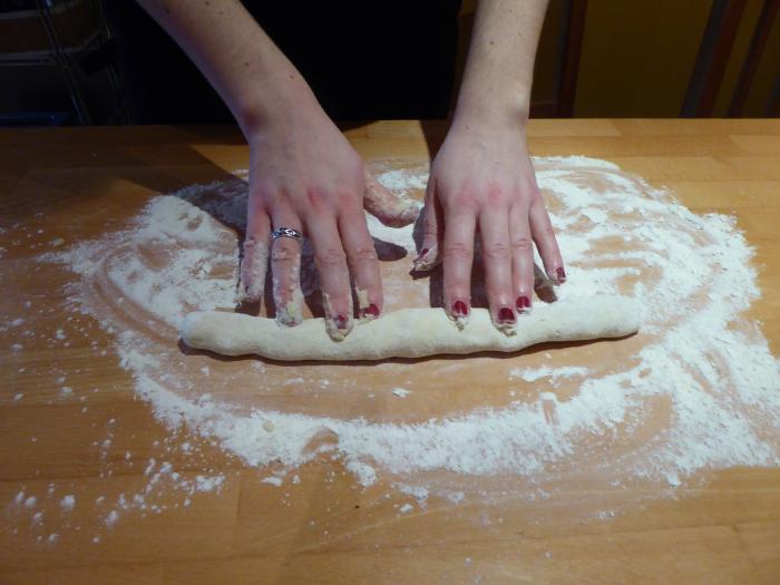 Gnocchi-Teig wird zu einer langen "Schlange" ausgerollt