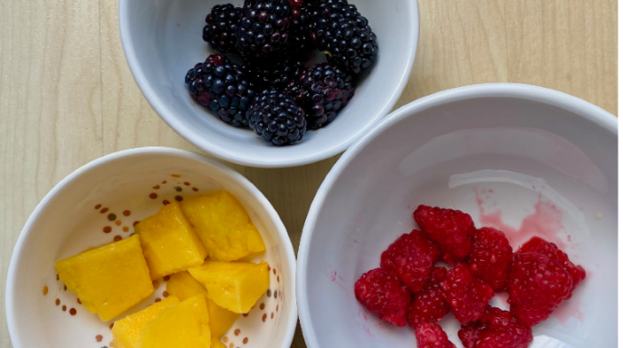 Zu sehen sind drei Schüsseln mit den verschiedenen Zutaten: Mango, Himbeere und Brombeere.