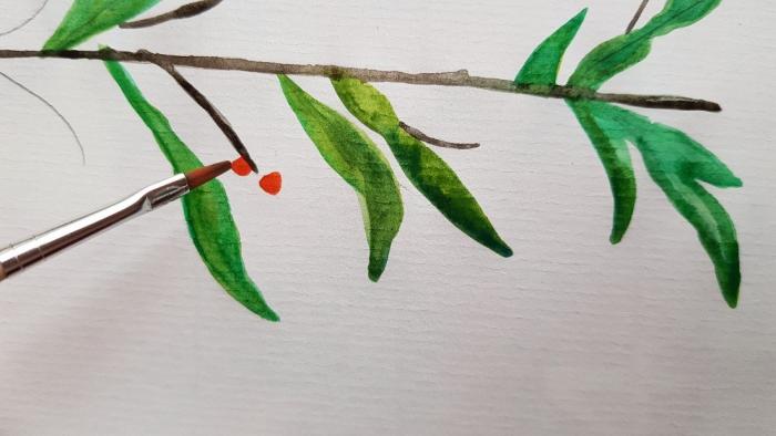 mit Aquarellfarben gemalter Ast mit grünen Blättern und roten Beeren